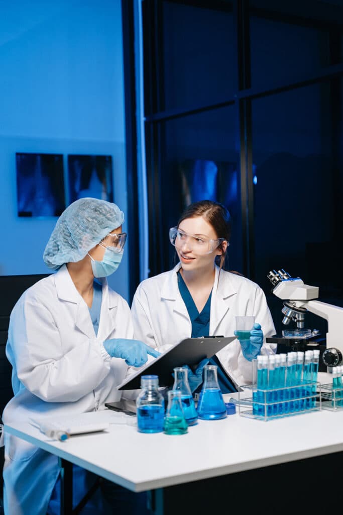 Pharmaceutical team reviewing data in a lab.